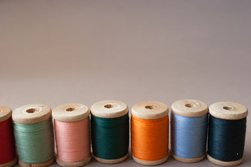 Colored yarns on wooden coils.