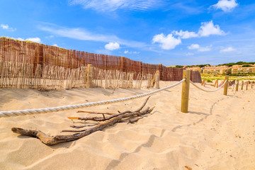 Sand dune and wind fence on Cala Mesquida beach, Majorca island, Spain