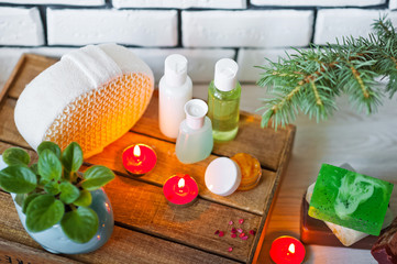 Photo of bathrooms, spa treatments. Transparent bottles, loofah, pieces of soap, bath salts, candles. Comfort and relaxation