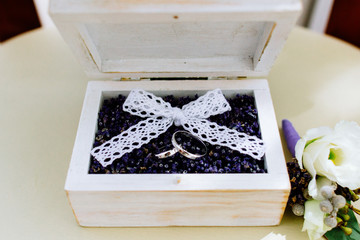  wedding rings in a box with lavender