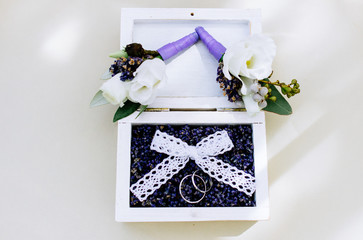  wedding rings in a box with lavender