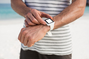 Midsection of man using smartwatch