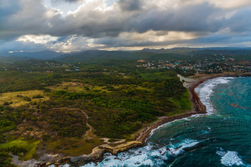 Aerial View of Hills, Valleys and a Rustic Caribbean Beach, in St. Lucia