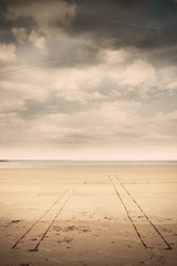 Cross against serene beach landscape