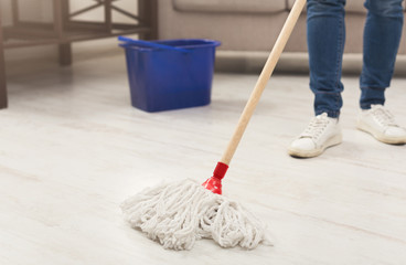 Unrecognizable woman with mop ready to clean floor