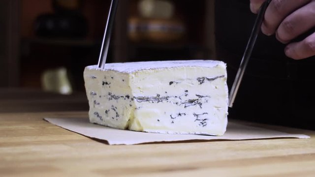 Cheese with blue mold. Blue cheese is cut into a string. 4k