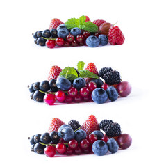 Ripe currants, blackberries, blueberries, strawberries and raspberries with mint leaves. Set of mix fruits and berries isolated on white background. Background of mix fruits on a white background.