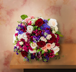 top view of a beautiful bouquet of flowers, multi-colored roses with green leaves