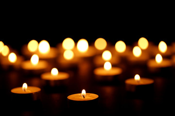 Burning candles on black background