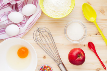 Ingredients for baking on the wooden background. Сookery, food, confectionery and home kitchen concept. Top view. Close up.