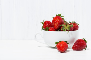 cup of fresh strawberries on a white background