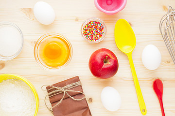 Ingredients for baking on the wooden background. Сookery, food, confectionery and home kitchen concept. Top view. Close up.