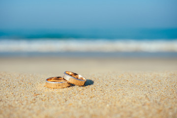 wedding rings on the background of the sea. concept of a wedding ceremony on the beach