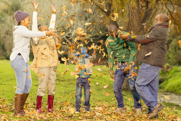 Happy family throwing leaves around