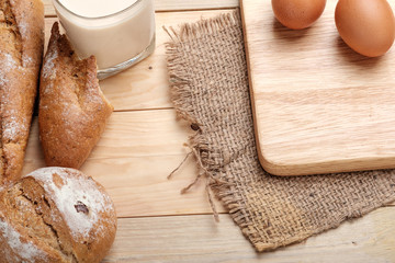 Fototapeta na wymiar Whole wheat bread on wooden background