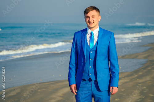 Beautiful And Handsome Groom In A Chic And Fashionable Blue Suit