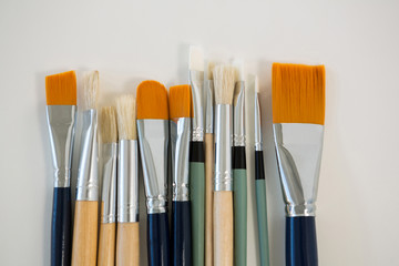 Various paintbrushes arranged in a row