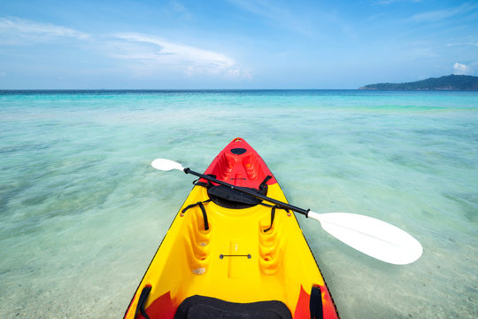 Colorful kayak on the tropical beach with blue sky