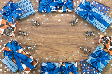 Gift boxes composition on wooden table. Flat lay text space.