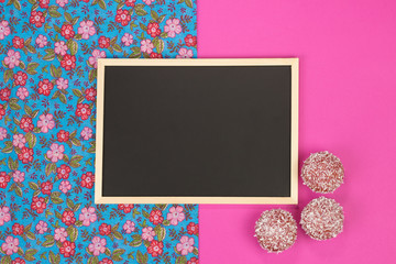 Empty chalkboard on pink background with copy space.