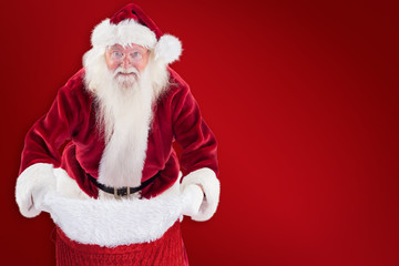 Santa open his red bag against red background