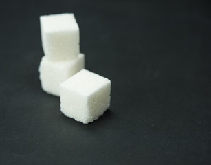sugar, white sugar in cubes, pressed sugar. Black background