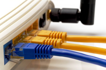 close up on three network cables connected to WAN and LAN ports on wi-fi router