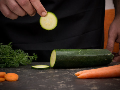 Cutting vegetables on a stone table for meal preparation