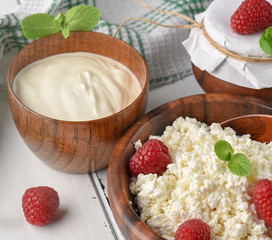 Dairy products milk cottage cheese, sour cream and fresh raspberry