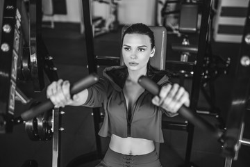 sexy girl doing exercises in her pectoral muscles in simulator. Gym Machine. nice cute female.