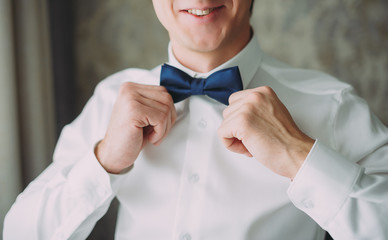 morning wedding preparations of a stylish groom. butterfly tie