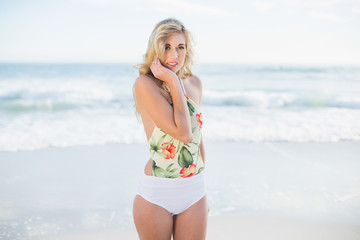 Fototapeta na wymiar Pensive blonde model in swimsuit posing looking at camera