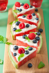 Fototapeta na wymiar watermelon pizza slices with yogurt and berries, summer dessert