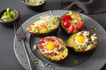eggs baked in avocado with bacon, cheese, tomato and alfalfa sprouts