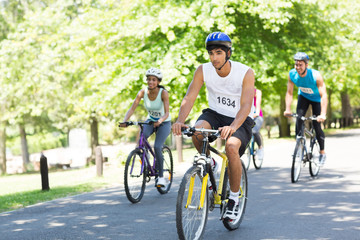 Fototapeta na wymiar Cyclists riding bicycles on street