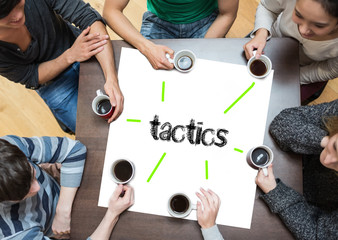 The word tactics on page with people sitting around table drinking coffee