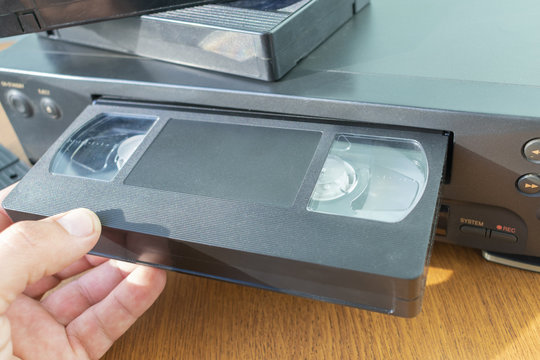 VHS Videocassette is Put into the Video Recorder To Watch the Video,  Another Video Cassette is on the Video-tape Recorder Stock Image - Image of  industry, electronics: 239016517