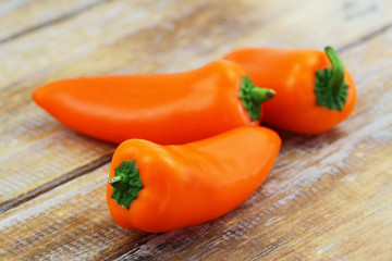 Crunchy snack paprika on wooden surface, closeup
