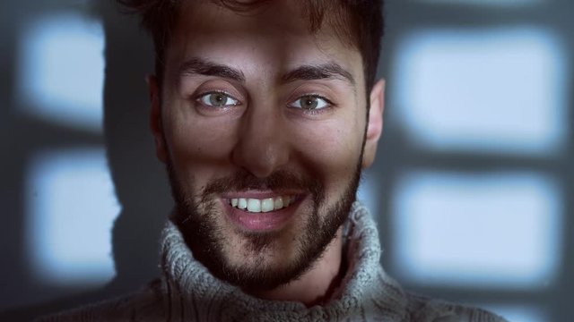 insanity, schizophrenia-Young Sinister man  Smiles at camera in the dark  