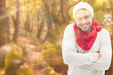 Naklejka na ściany i meble Handsome hipster against tranquil autumn scene in forest
