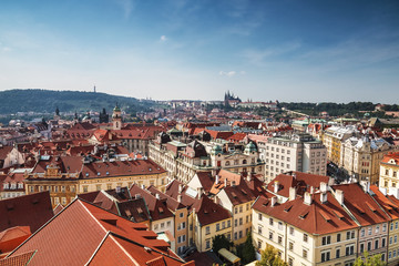 View of the red roofs of Prague and St. Vitus Cathedral on the horizon. Czech Republic