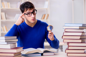 Male student preparing for exams in college library