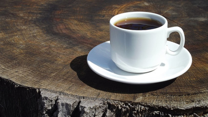 Cup of aromatic coffee on wooden background.