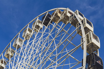 Attraction of the Ferris wheel against the sky with clouds