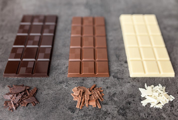 Delicious variety of chocole on rustic background