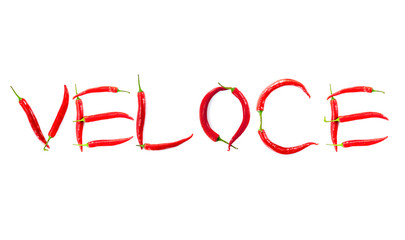 italian word veloce meaning quick written with red chili peppers on white background abstract concept photo