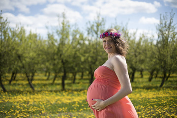 Fototapeta na wymiar Pregnant woman in the meadow