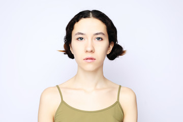 Fototapeta premium Young cheerful girl looking at camera over white background.