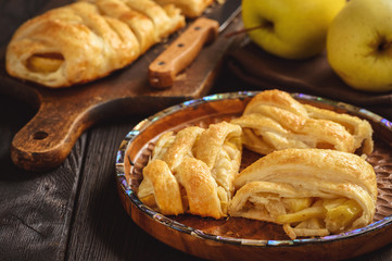 Apple puff pastry braid, on dark background.