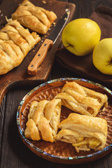 Apple puff pastry braid, on dark background.